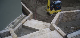 Treppenanlage aus Granitstufen passend mit Palisaden eingefasst